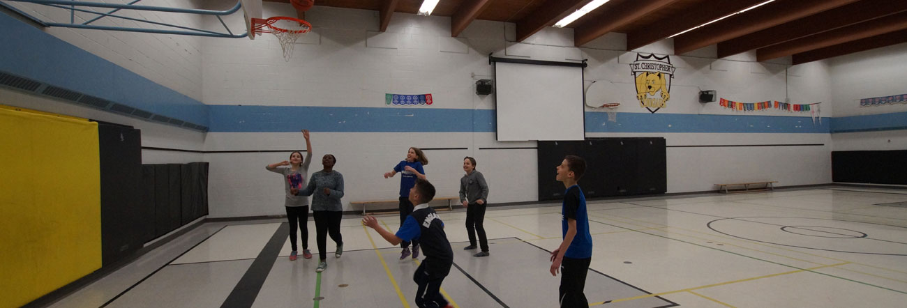 Students playing basketball in gym